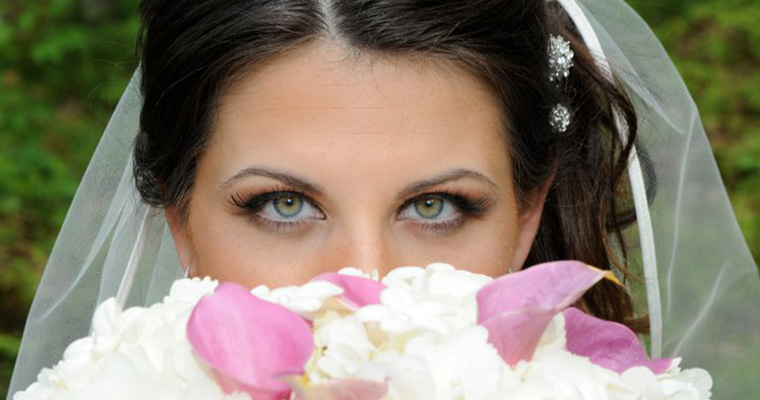 bride looking over bouquet of flowers
