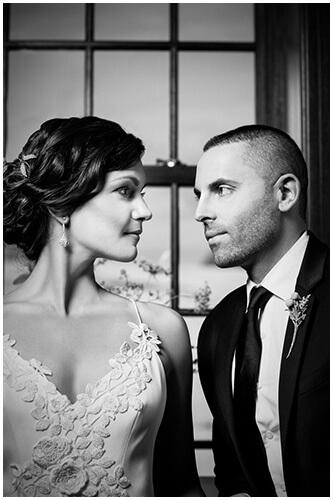 black and white photo of bride and groom close together looking at each other